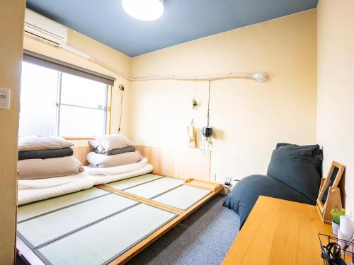 a room with a bed and pillows on it at WE HOME HOTEL and KITCHEN 市川 船橋 in Ichikawa