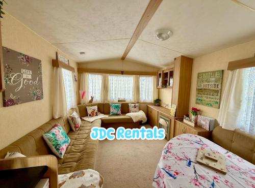 a room with a couch and a bed in a room at Palins - KC19 in Kinmel Bay