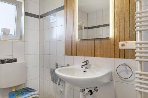 a white bathroom with a sink and a toilet at Appartement Panoramablick in Lustenau