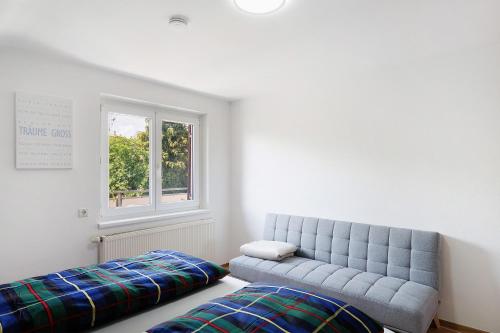 a living room with a couch and a window at Appartement Panoramablick in Lustenau