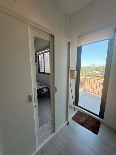 a room with a sliding glass door with a balcony at RF Condotel in Mactan Island