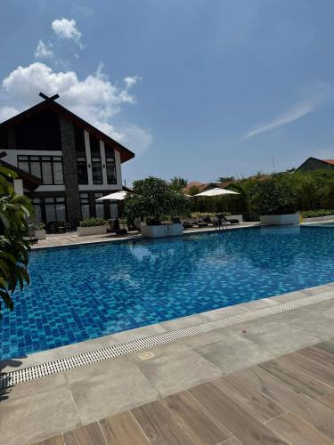 a large swimming pool in front of a building at RF Condotel in Mactan Island