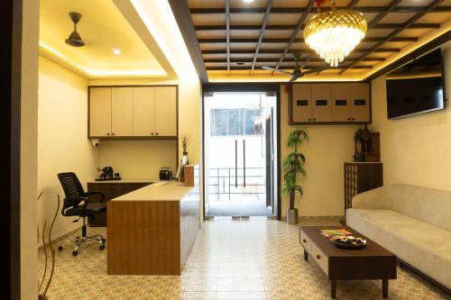 a living room with a couch and a table at Hotel Liora in Rajkot
