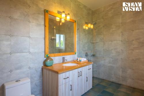 a bathroom with a sink and a mirror at StayVista at The Hideout Farms with Lawn and private Pool in Kurukshetra