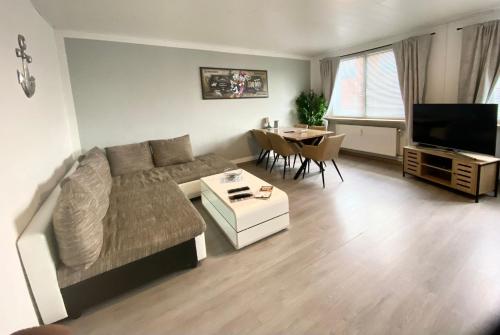 a living room with a couch and a table at Ferienwohnung Freedom 1 Sky Terrasse High End in Northeim