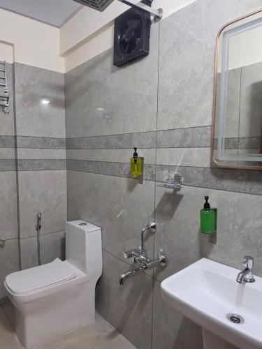 a bathroom with a toilet and a sink at Tara inn in Alwaye