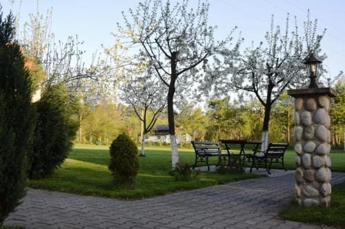 a park with benches and a table and trees at Domki Cztery Pory Roku in Czchów