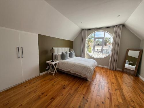 a bedroom with a bed and a large window at The Nathaniel in Blue Bend
