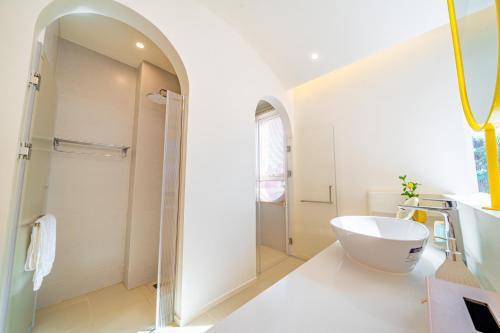 a white bathroom with a shower and a sink at Candy House Private Pool Villa & KTV in Ban Nong Chaeng