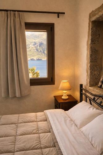 a bedroom with a bed and a window at Castello in Porto Kagio
