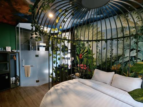 a bedroom with a bed with plants on the wall at Min Boutique Hotel in Hà Ðông
