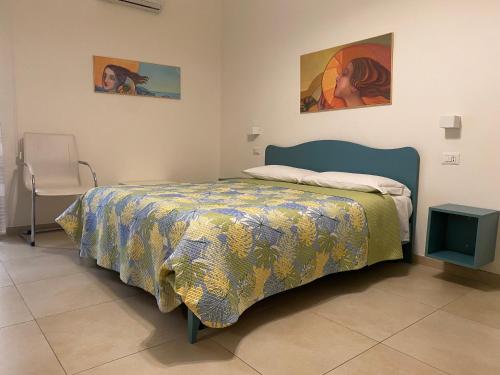 a bedroom with a bed with a colorful comforter at B&B Vento di Terra in Gaeta