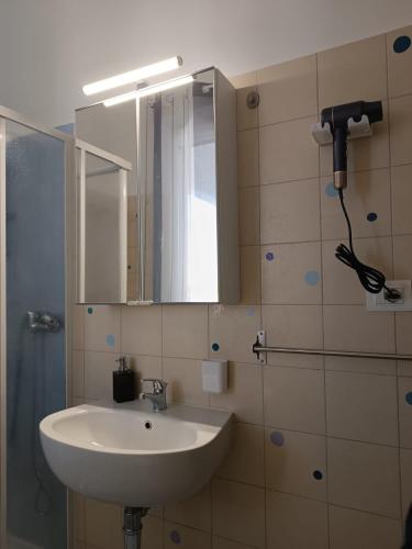 a bathroom with a sink and a mirror at Casa Tamerici in Marcelli