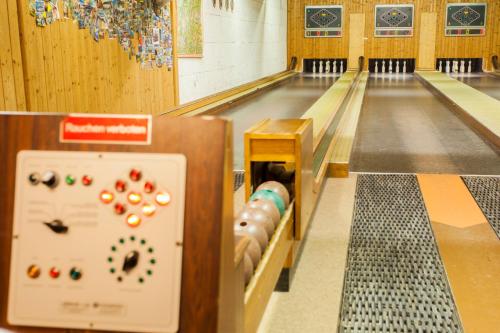 an empty bowling alley with pins in the lanes at Hotel Alpenblick in Bach