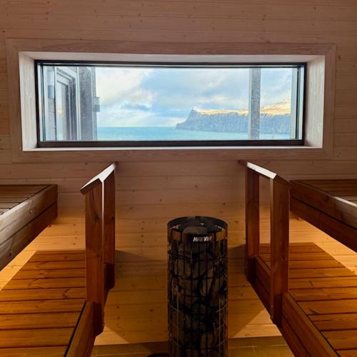 a room with a large window in a room with wooden floors at Luxury Nordic Lodge with private Sauna in Glendale