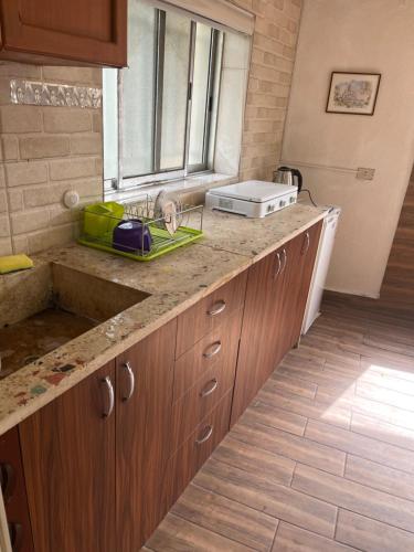 a kitchen counter with a sink and a window at Batroun Souq, Perfect location, 1 Bedroom in Batroûn