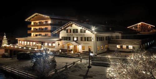 a large building with christmas lights in front of it at Hotel Alpenblick in Bach