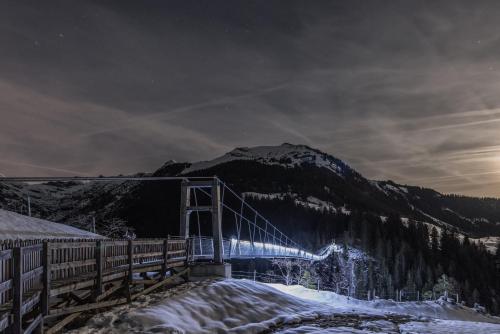 a train on a bridge over a snow covered mountain at Hotel Alpenblick in Bach