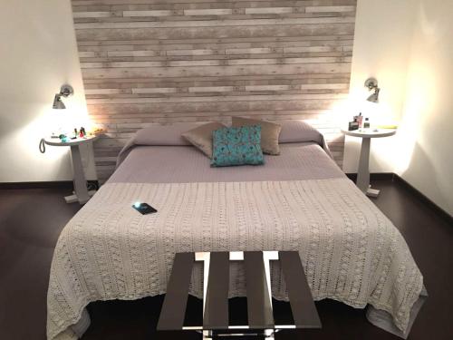 a bedroom with a large bed with two tables at Relais Villa D'Assio in Labro Rieti
