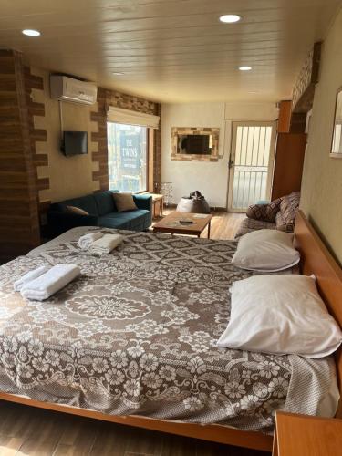 a large bed with two pillows on top of it at Batroun Souq, Perfect location, 1 Bedroom in Batroûn