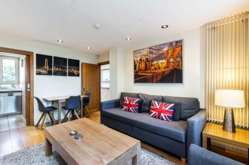 a living room with a couch and a table at Tower Bridge 2BR apartment for 6 with terrace in London
