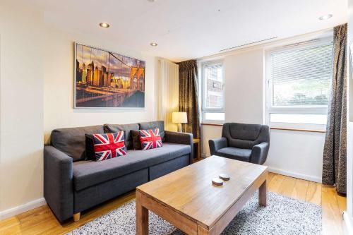 a living room with a couch and a coffee table at Tower Bridge 2BR apartment for 6 with terrace in London