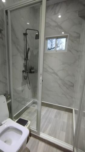 a bathroom with a shower and a toilet at Selah Hotel Dipolog in Dipolog