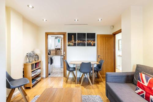 a living room with a couch and a table at Tower Bridge 2BR apartment for 6 with terrace in London
