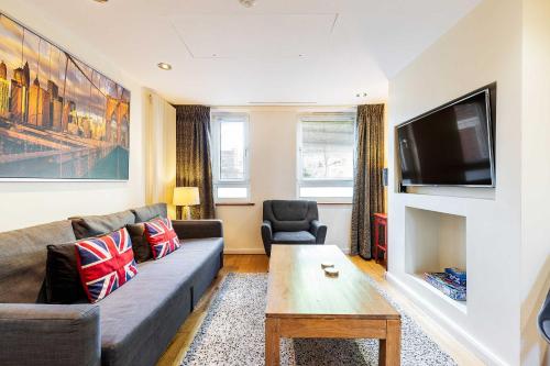 a living room with a couch and a tv at Tower Bridge 2BR apartment for 6 with terrace in London