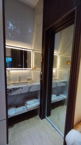 a bathroom with a sink and a mirror at Selah Hotel Dipolog in Dipolog