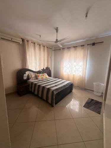 a bedroom with a bed in a room with a window at Ahfash Homes in Mombasa