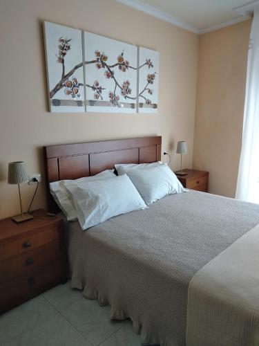 a bedroom with a large bed with white pillows at Cristel in Puentecesures