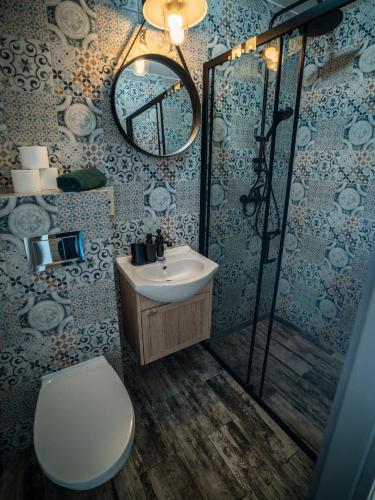 a bathroom with a toilet and a sink and a shower at Perła Turawa in Turawa
