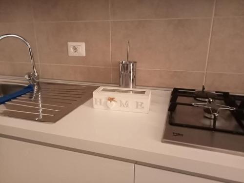 a kitchen counter with a sink and a stove at Residenza Delizia in Gallipoli
