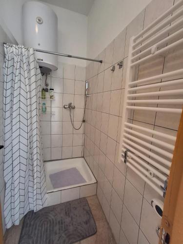 a bathroom with a shower with a shower curtain at Benkovac sobe in Benkovac