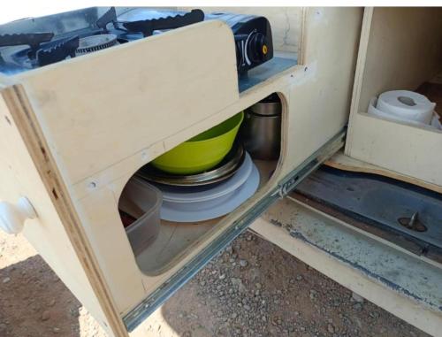 a drawer in a cabinet with some dishes in it at Tenerife Camper Van Teide Surf and Beaches Sleeps 2 in San Miguel de Abona