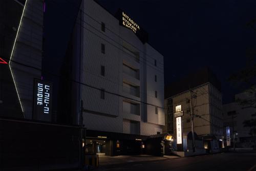 a building with a sign on the side of it at night at Mitasuya Ryokan Hotel by Anook Gwangju in Gwangju