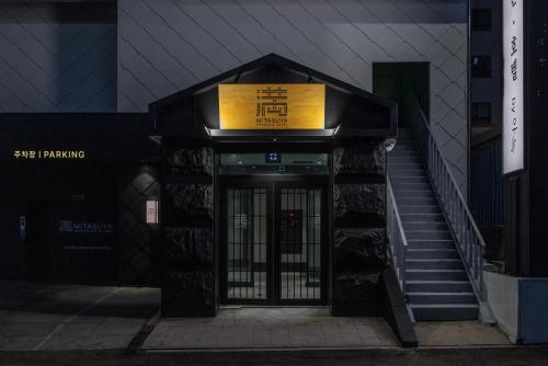 an entrance to a building with a sign above a door at Mitasuya Ryokan Hotel by Anook Gwangju in Gwangju