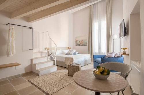 a living room with a bed and a table at Palazzo Mulini in Monopoli