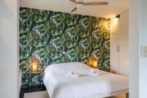 a bedroom with a green wall with a white bed at Amazing villa for 8 in Bredene in Bredene