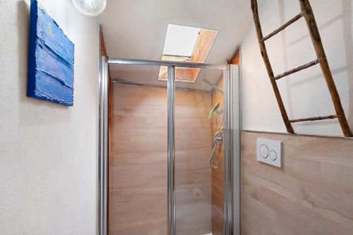 a shower in a bathroom with a glass door at La Volta Segreta in Albenga