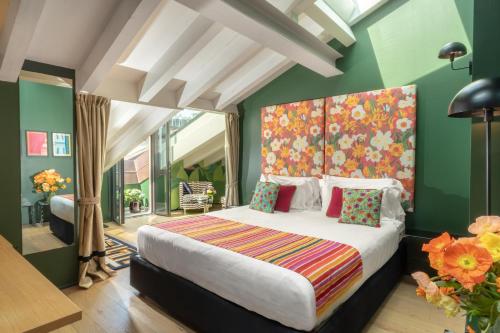 a bedroom with a large bed and green walls at Speronari Suites in Milan