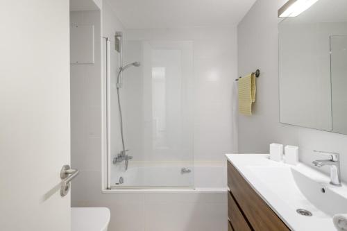 a white bathroom with a shower and a sink at Golf Mar I H5 in Pals
