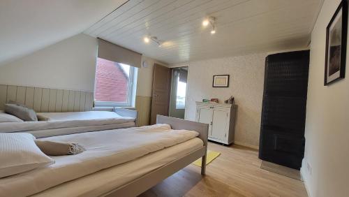 a bedroom with two beds and a window at Kose apartment in Kose
