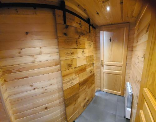 a small room with wooden walls and a door at Chalet Les Vosgiennes in Le Valtin