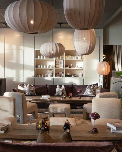 a living room with couches and tables and lights at Sankt Jörgen Park in Gothenburg