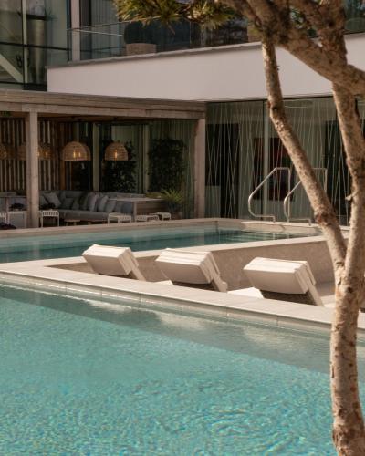 a swimming pool with lounge chairs in a building at Sankt Jörgen Park in Gothenburg
