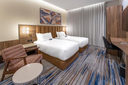 a hotel room with two beds and a desk at فندق لفيف العريض - Lafeef Hotel Al-Aridh in Medina