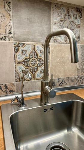 a sink with a faucet in a kitchen at Canoa Studio Vlc & Free filtered drinking water in Valencia