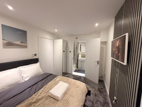 a bedroom with a large bed and a bathroom at Luxury Rooms - Pick a Room - Free Parking & Kitchen Access, Near Etihad Stadium, The Coop Live & Piccadilly Station, Manchester in Manchester